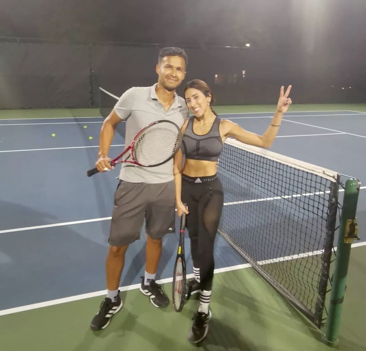 Pablo and a student at the net under the lights
