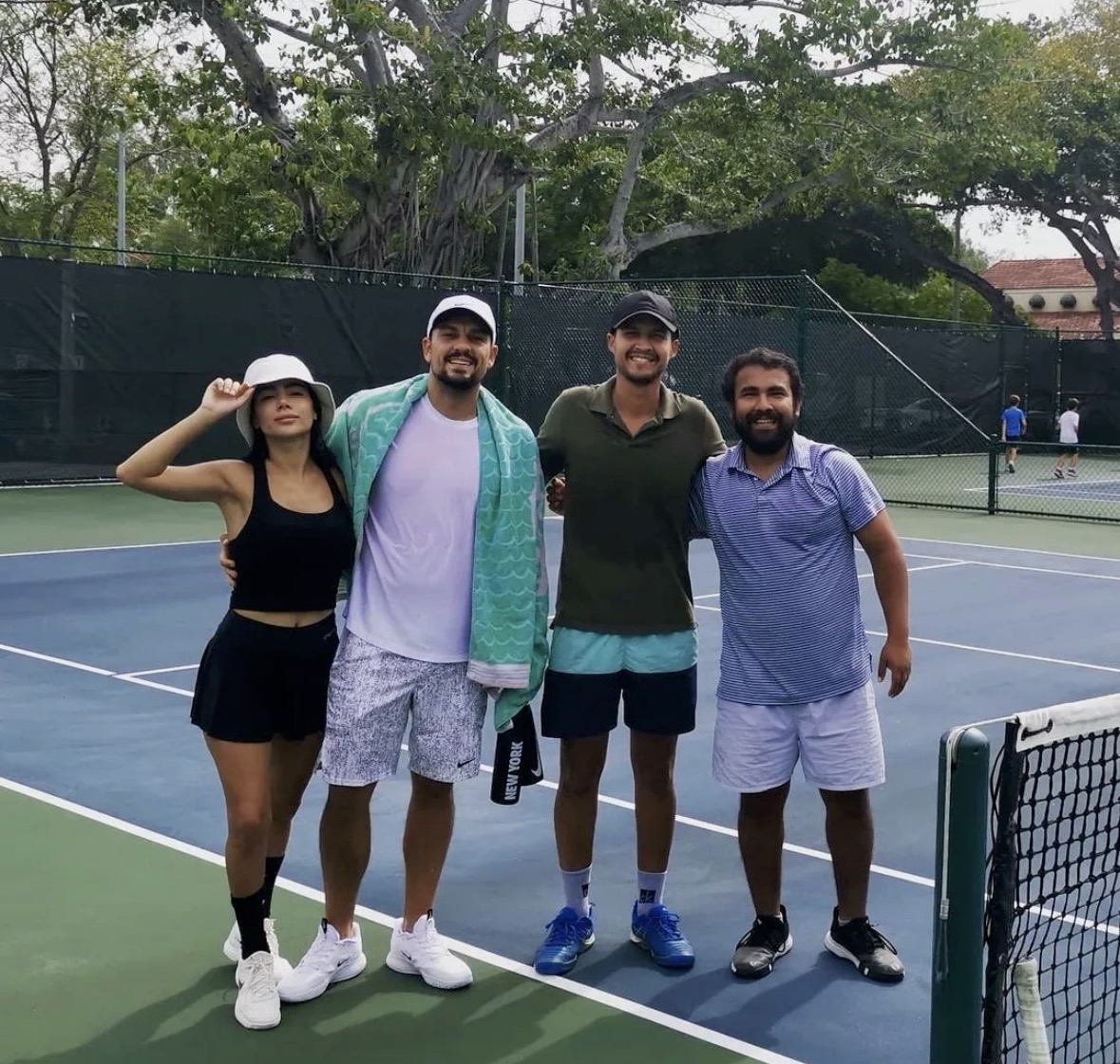 Pablo with a group of players courtside